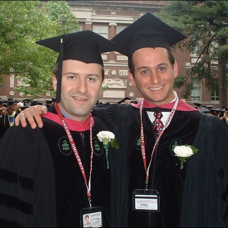 Alexander Kutikov and Todd Morgan in caps and gowns at their medical school graduation in 2003